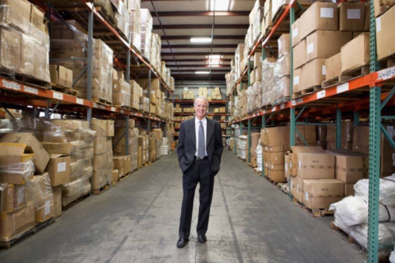 Man-standing-in-flooring-warehouse